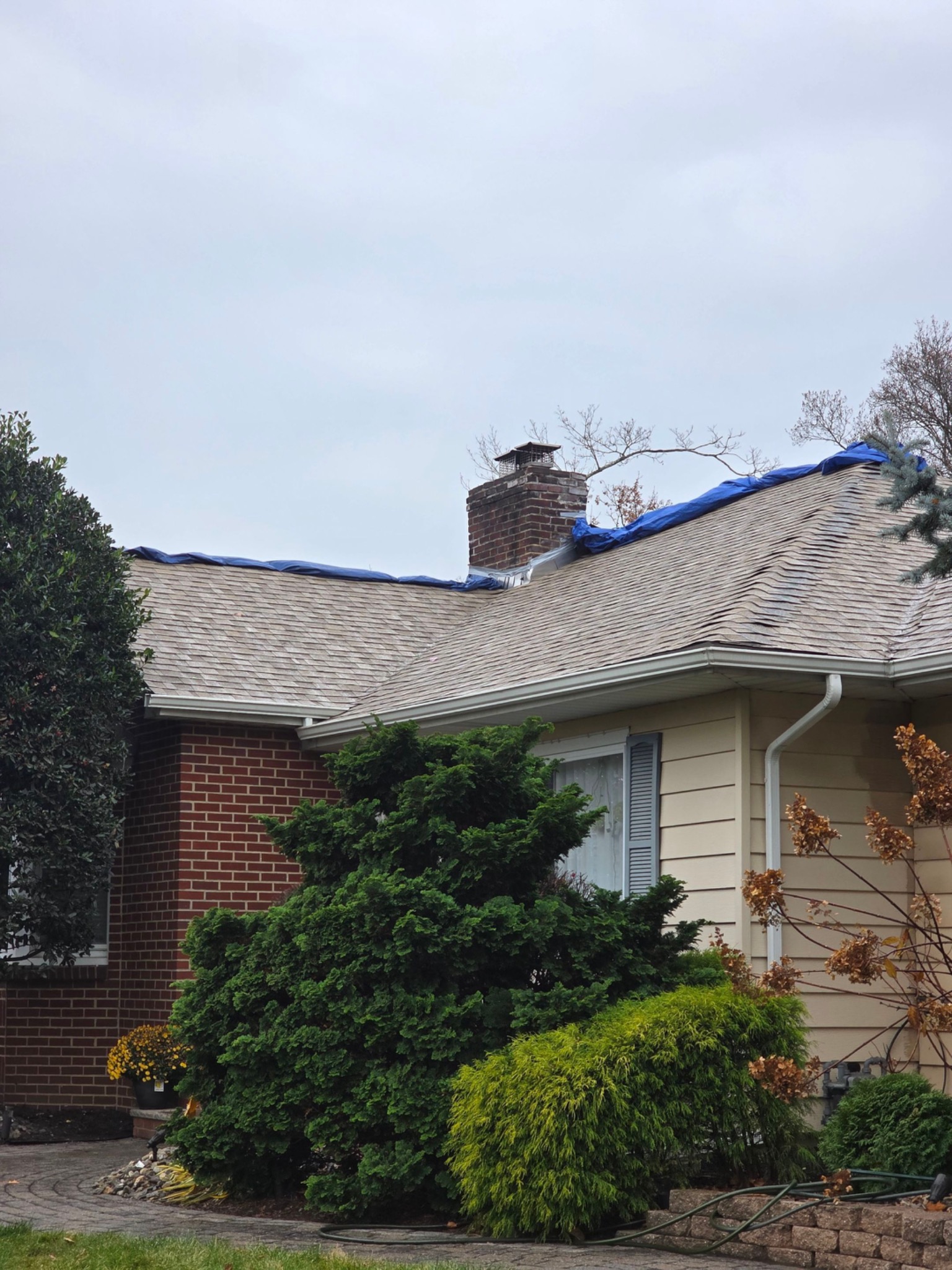 Before: storm-damaged roof under tarp in New Jersey