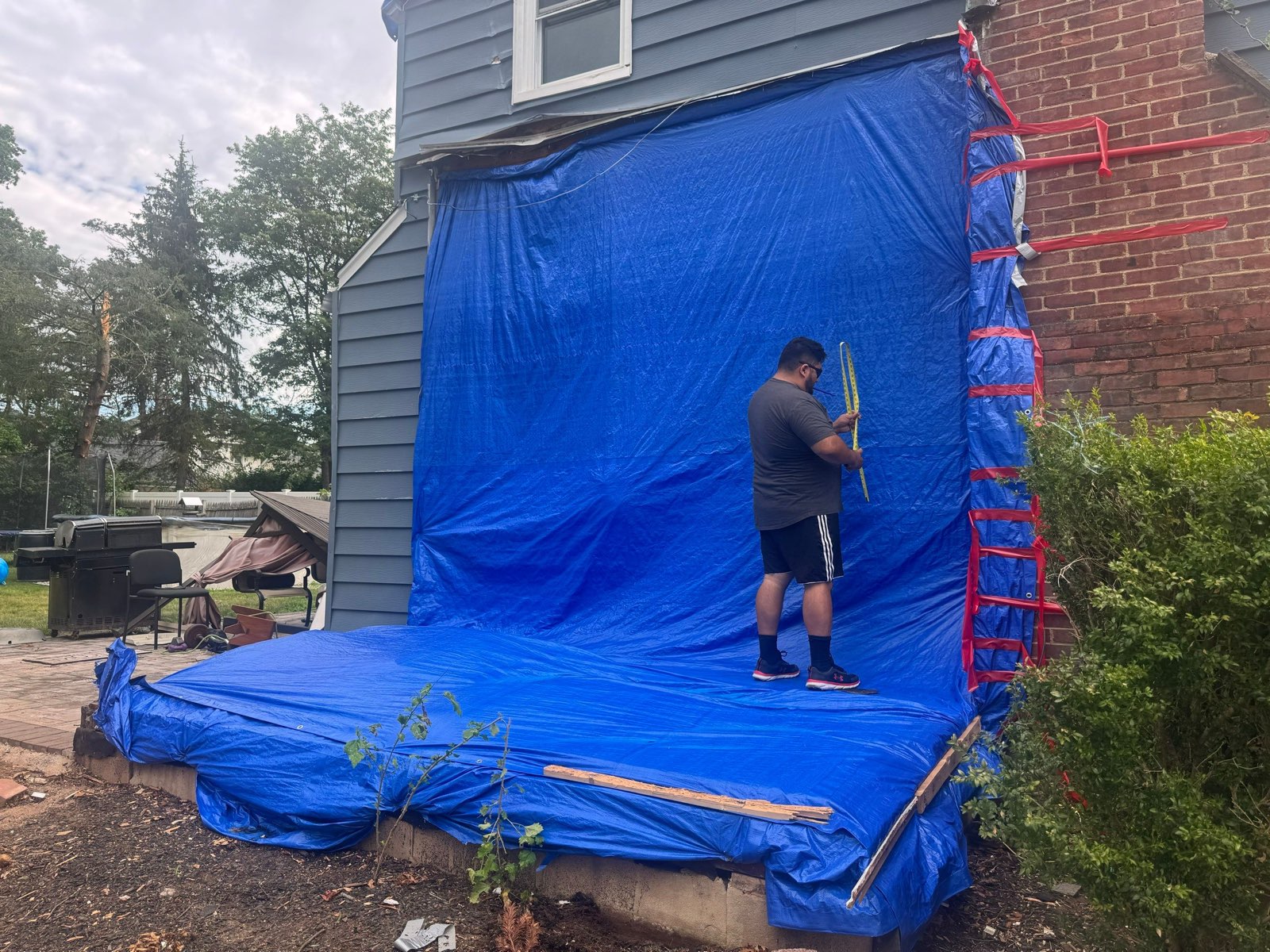 The damaged side sealed under a secured tarp