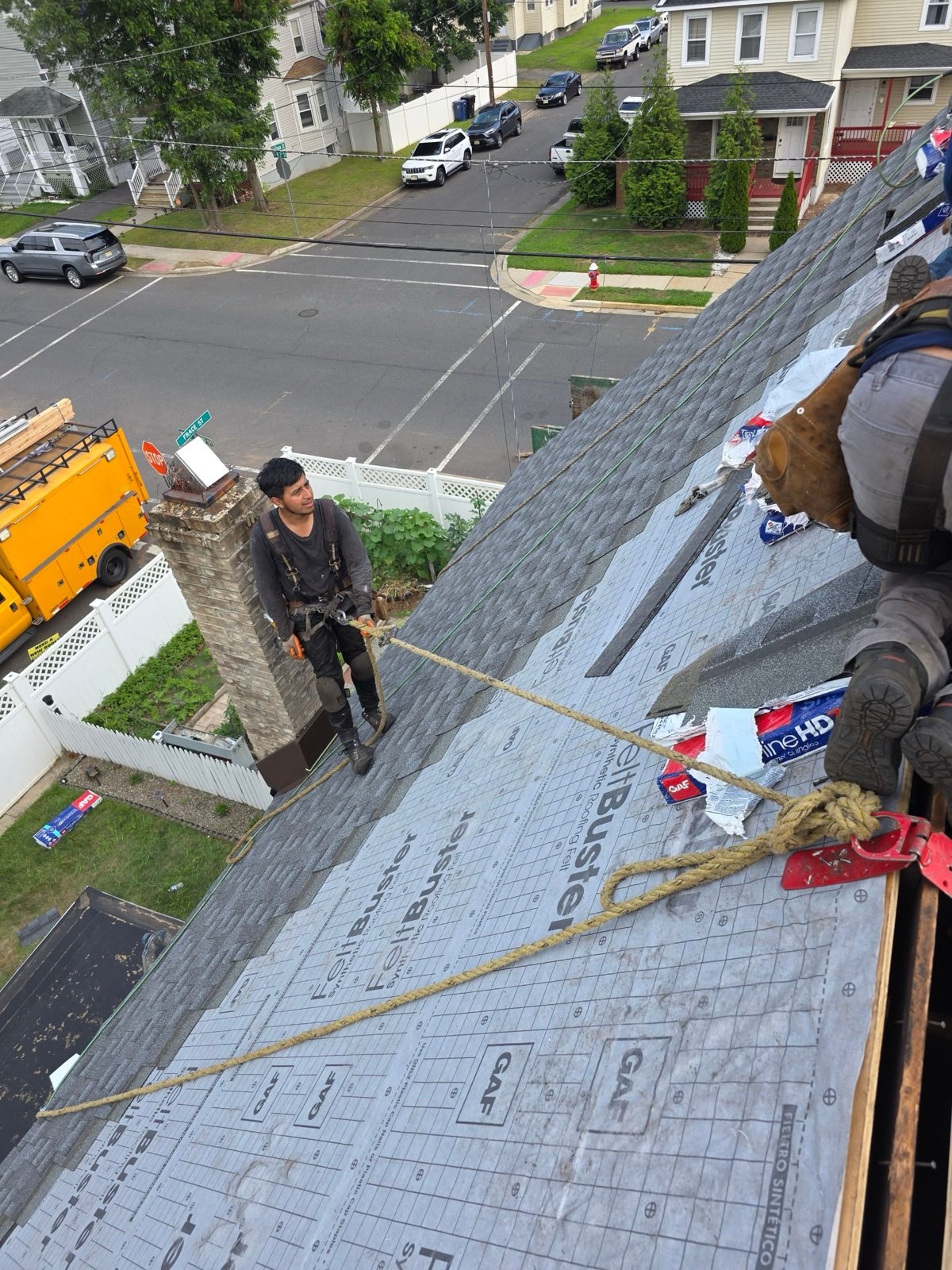 Harnessed crew installing GAF Timberline HDZ on the steep turret